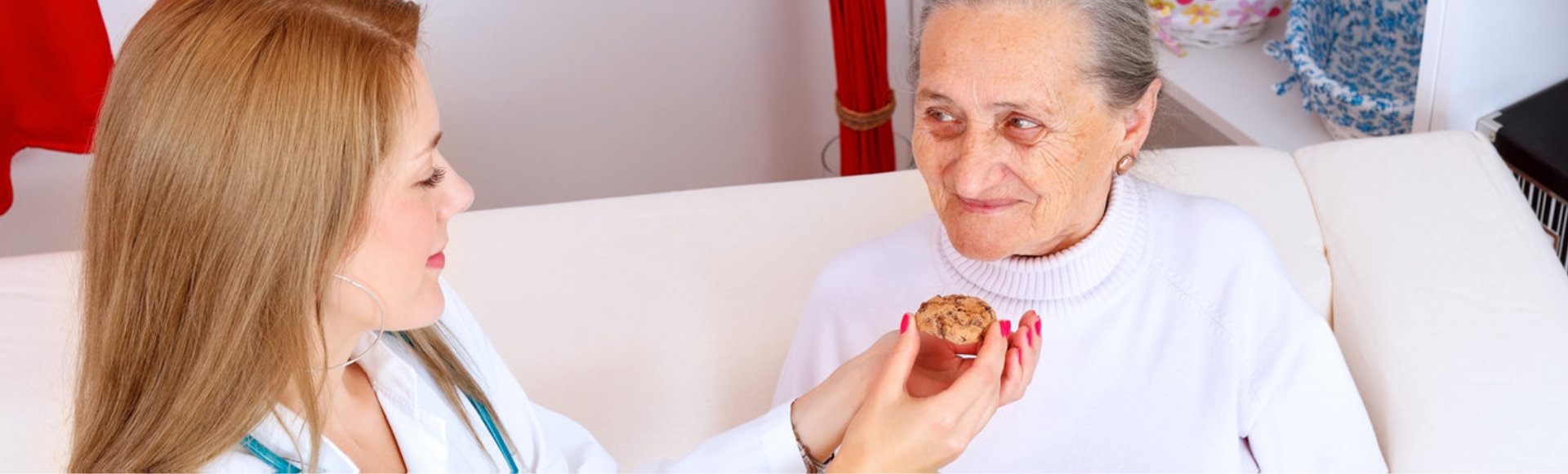 caregiver giving food to her patient